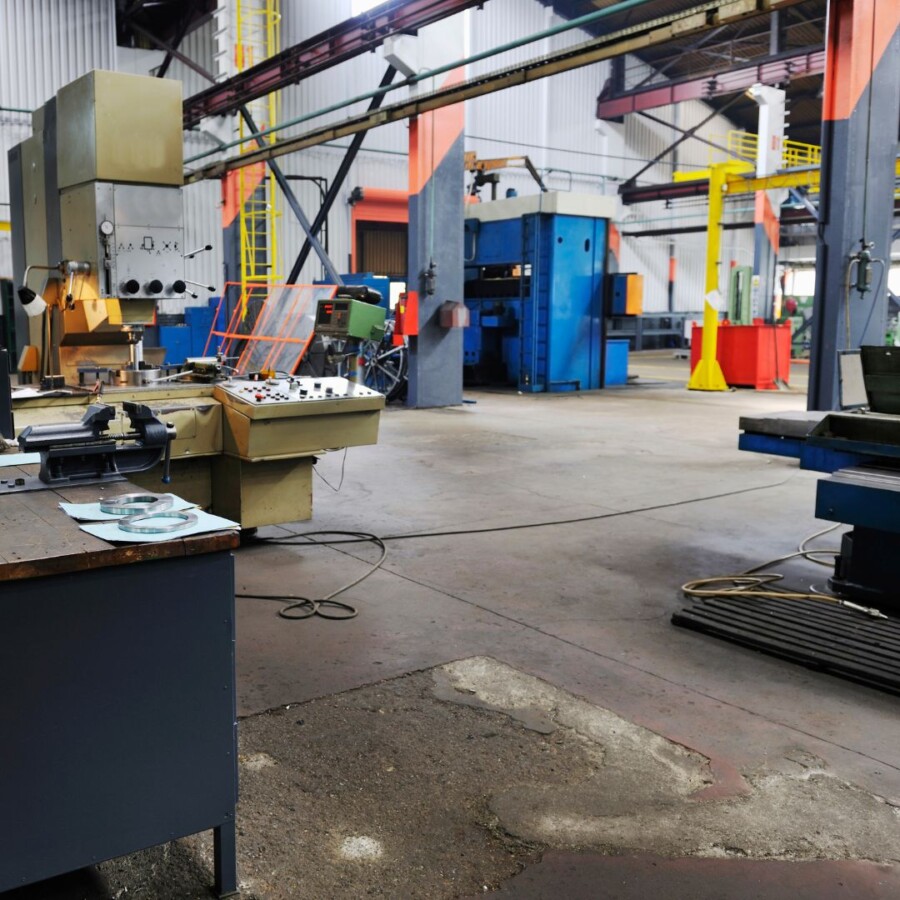 Interior of an industrial workshop with machinery, workstations, and manufacturing equipment, representing risks covered under commercial combined insurance.