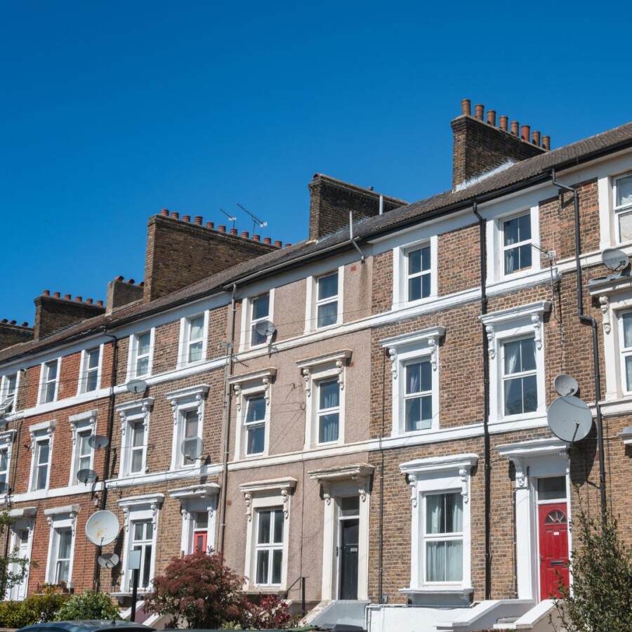 Row of traditional UK terraced residential properties photographed on a clear day, representing buildings covered under residential and commercial property owners’ insurance.